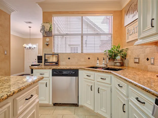 a kitchen with stainless steel appliances granite countertop a stove top oven a sink and a refrigerator