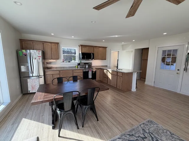 a view of kitchen with refrigerator microwave and wooden floor