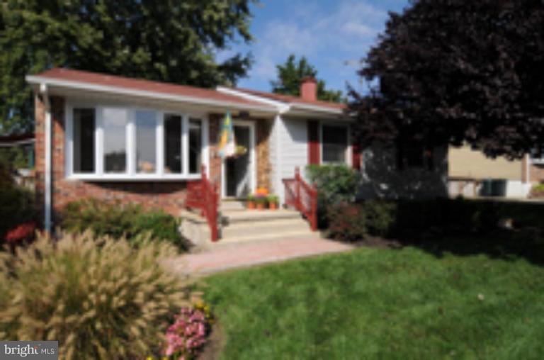 9118 Kilbride Road Nottingham, MD 21236 - Photo 2 of 22 a front view of a house with a yard and green space