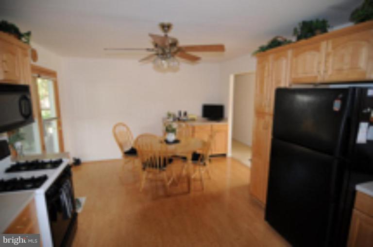 9118 Kilbride Road Nottingham, MD 21236 - Photo 21 of 22 a dining room with furniture and a flat screen tv