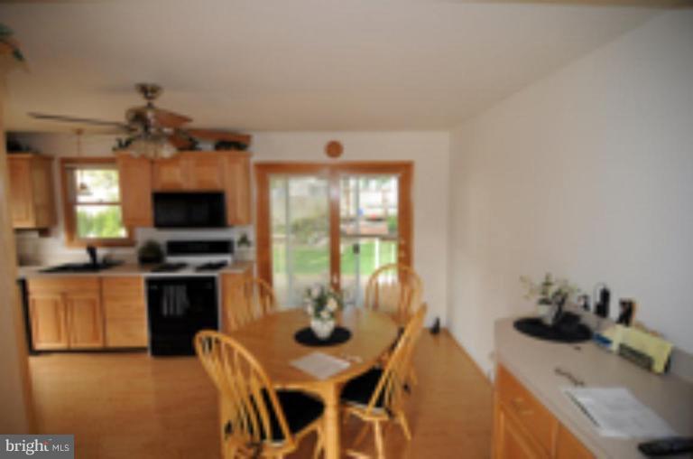 9118 Kilbride Road Nottingham, MD 21236 - Photo 5 of 22 a view of a dining room with furniture window and outside view