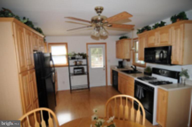 9118 Kilbride Road Nottingham, MD 21236 - Photo 6 of 22 a kitchen with stainless steel appliances granite countertop a refrigerator a stove top oven a sink and dishwasher