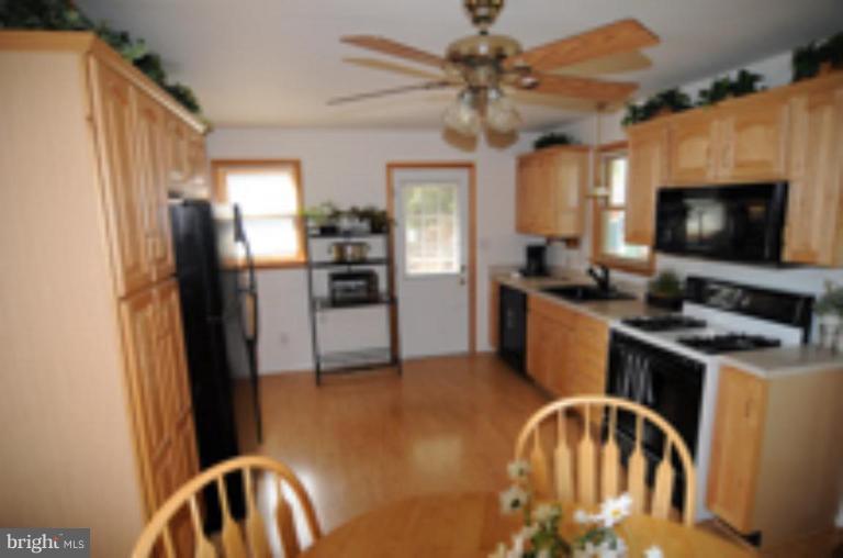 9118 Kilbride Road Nottingham, MD 21236 - Photo 7 of 22 a kitchen with a refrigerator a stove a sink and a microwave