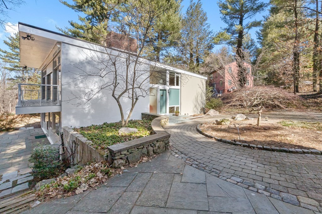 a view of a house with backyard and sitting area