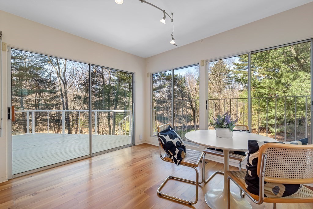 5 Field Road Lexington, MA 02421 - Photo 12 of 31 a dining room with wooden floor glass table and chairs
