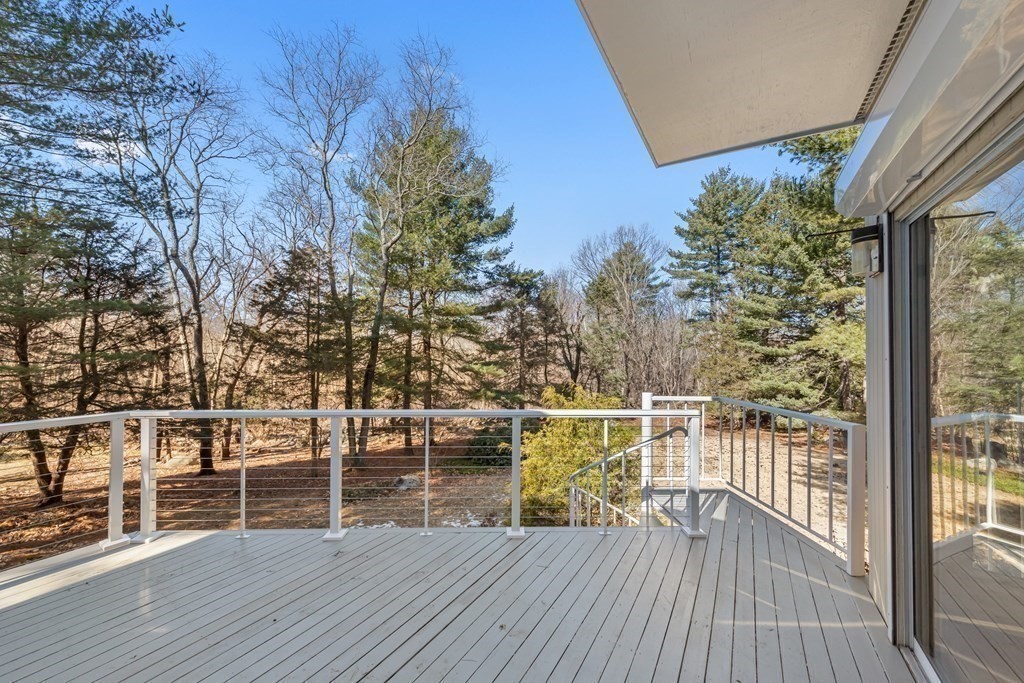 5 Field Road Lexington, MA 02421 - Photo 24 of 31 a view of a deck with wooden floor and bench next to a yard