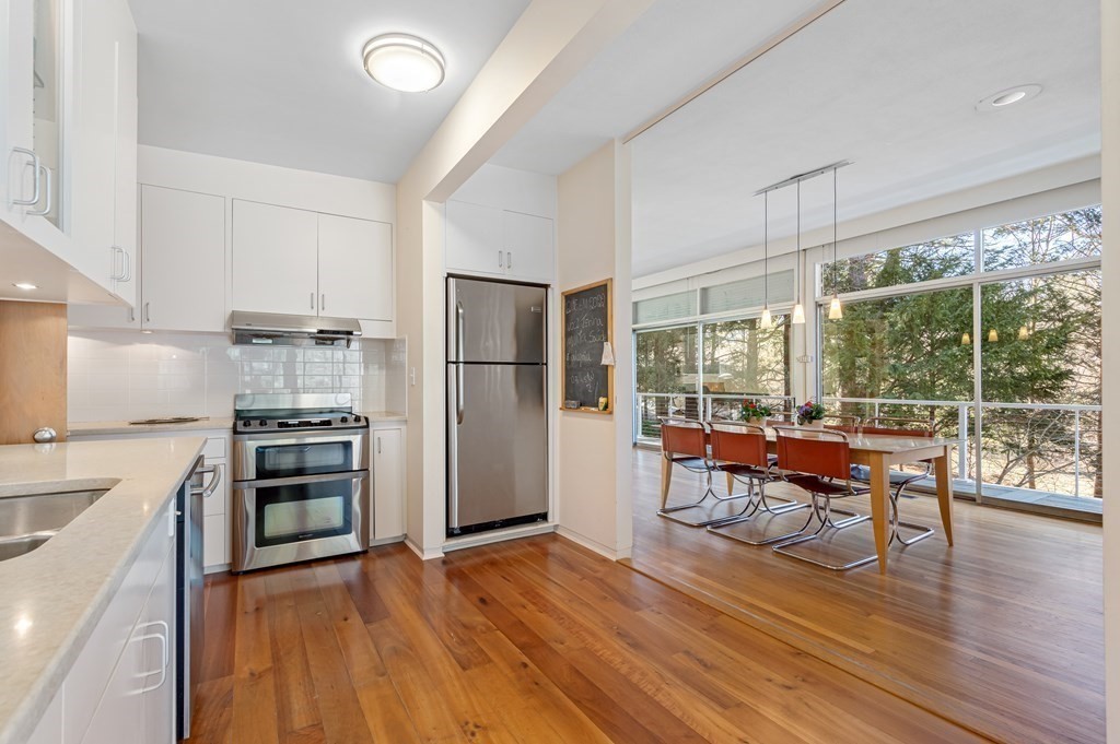 5 Field Road Lexington, MA 02421 - Photo 9 of 31 a kitchen with stainless steel appliances a stove top oven and a refrigerator