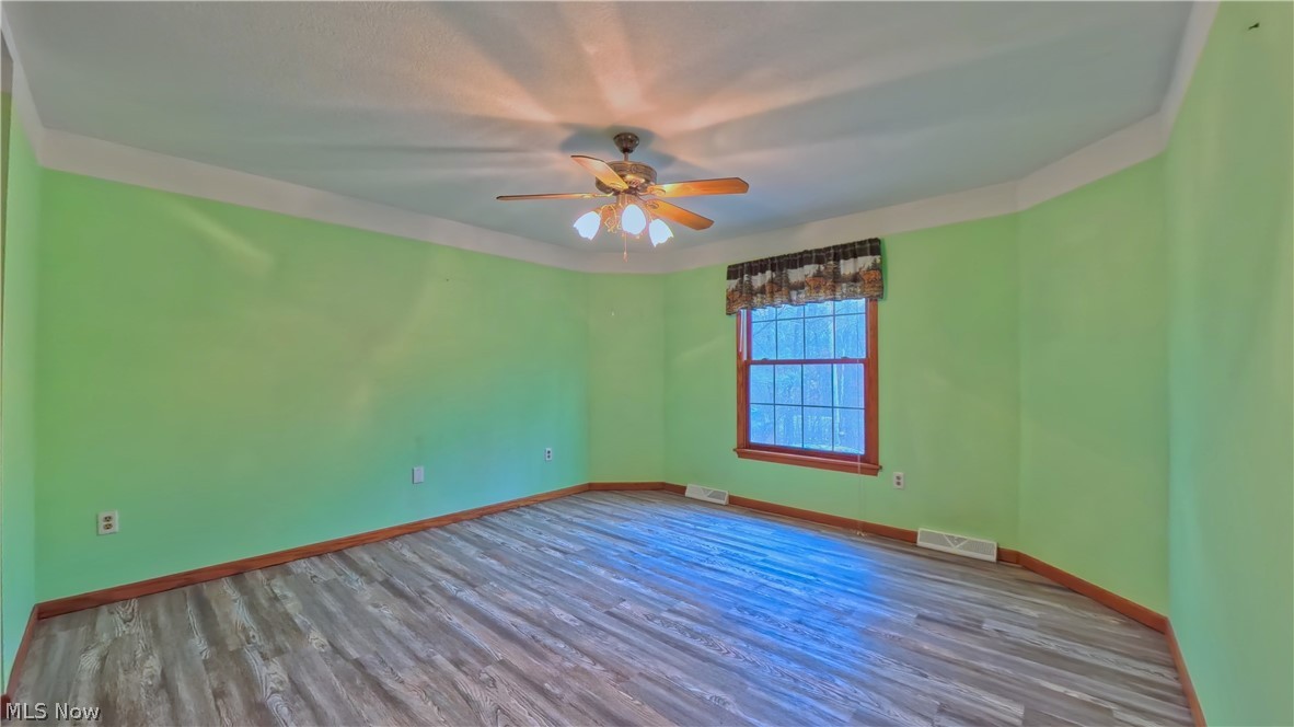 48276 Dyke Road Negley, OH 44441 - Photo 10 of 30 Unfurnished room with wood finished floors and ceiling fan