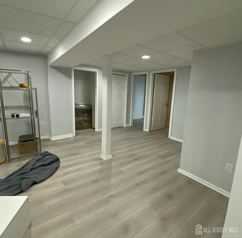 a view of a hallway with wooden floor and closet