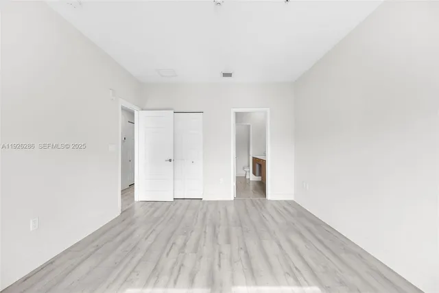 a bedroom with a bed and two windows