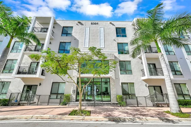 a kitchen with a sink a stove a refrigerator and a microwave