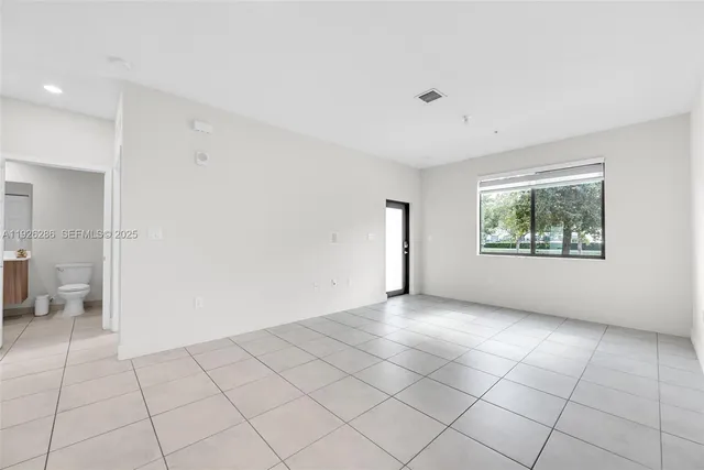 a view of a kitchen with a sink and a refrigerator