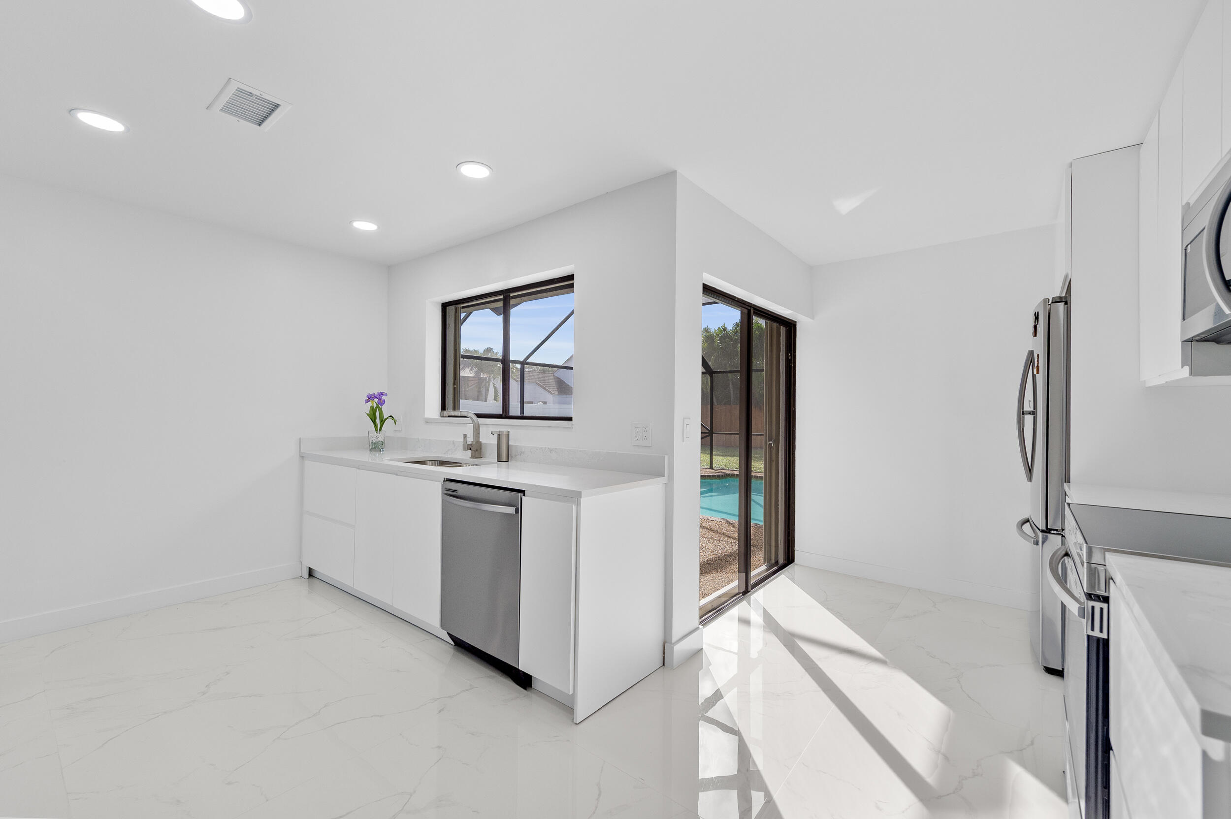 22301 Ensenada Way Boca Raton, FL 33433 - Photo 17 of 44 a kitchen with a sink stove and refrigerator