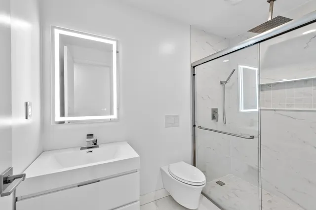 a bathroom with a sink toilet and shower