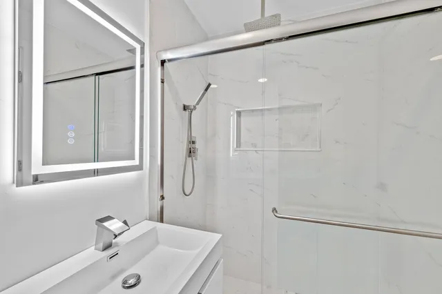 a bathroom with a sink and shower