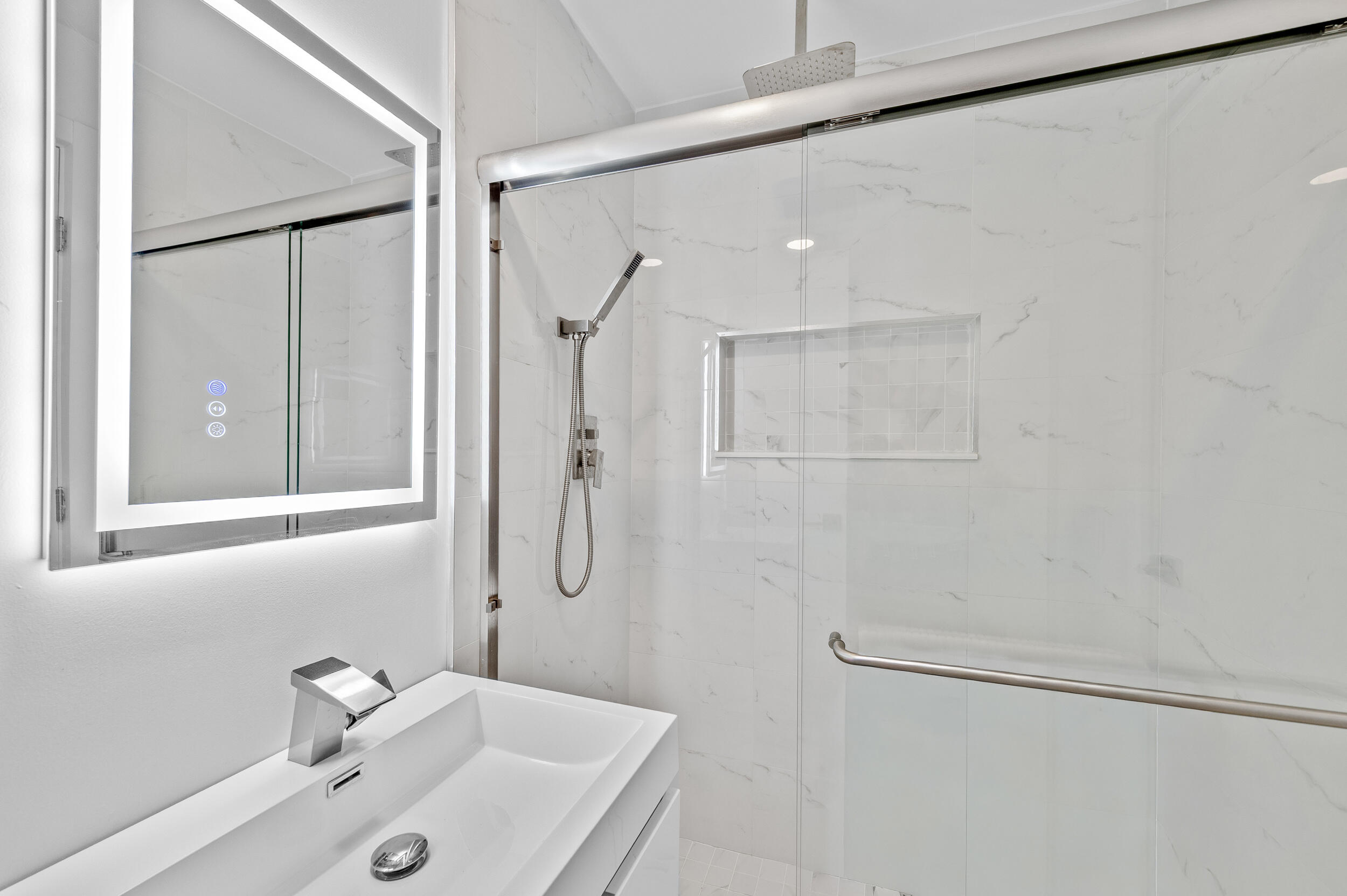 22301 Ensenada Way Boca Raton, FL 33433 - Photo 27 of 44 a bathroom with a sink and shower