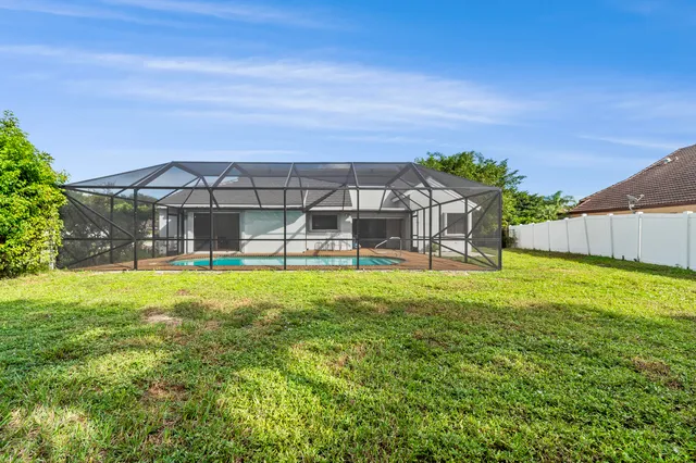 a view of a house with a backyard