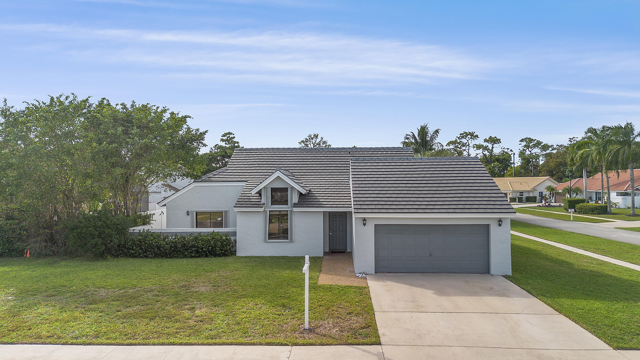 22301 Ensenada Way Boca Raton, FL 33433 - Photo 35 of 44 a front view of a house with a yard