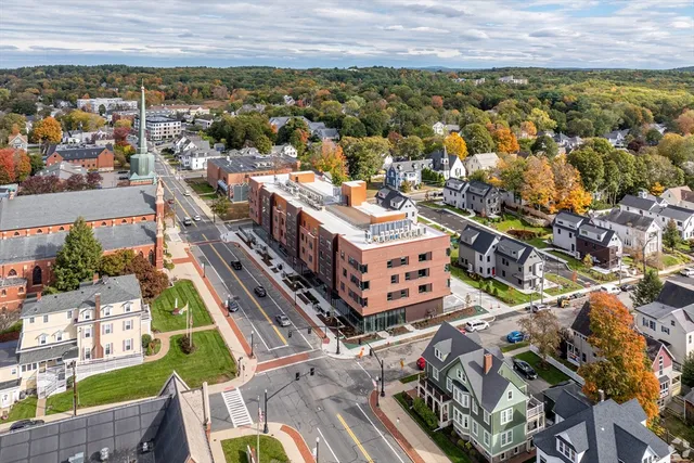 an aerial view of a residential apartment building with a yard