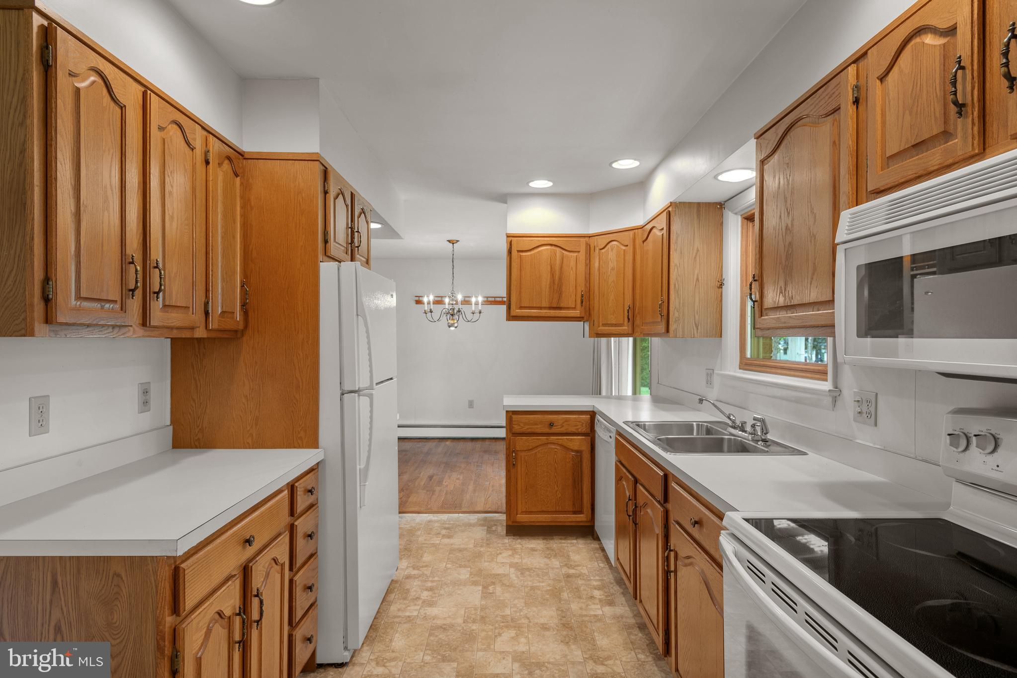 27 Pfautz Avenue Lititz, PA 17543 - Photo 12 of 25 a kitchen with stainless steel appliances granite countertop a sink stove and refrigerator