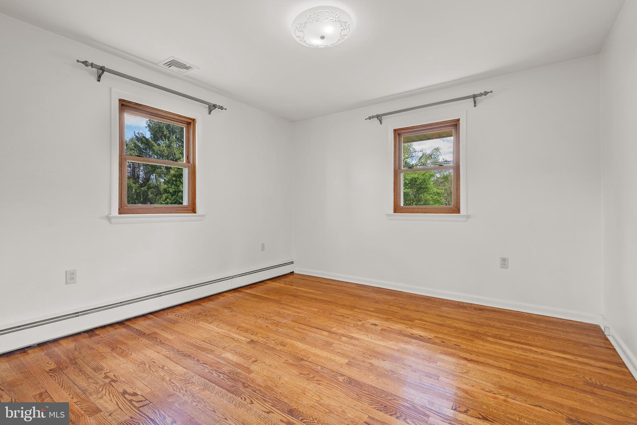 27 Pfautz Avenue Lititz, PA 17543 - Photo 17 of 25 a view of an empty room with wooden floor and a window