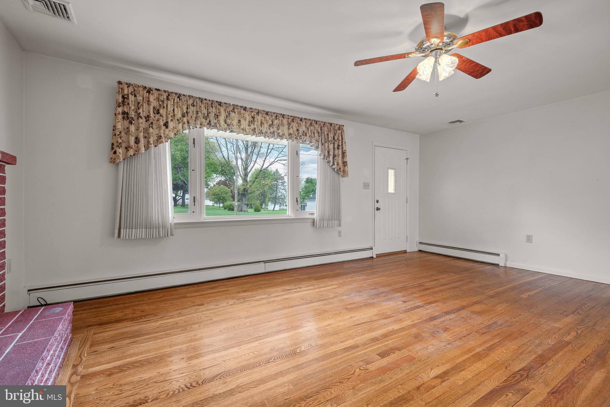 27 Pfautz Avenue Lititz, PA 17543 - Photo 5 of 25 a view of an empty room with wooden floor and a window