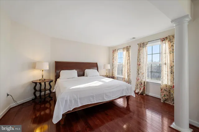 a bedroom with a bed and a large window