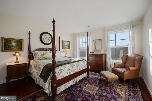 a bedroom with a bed couch and a window