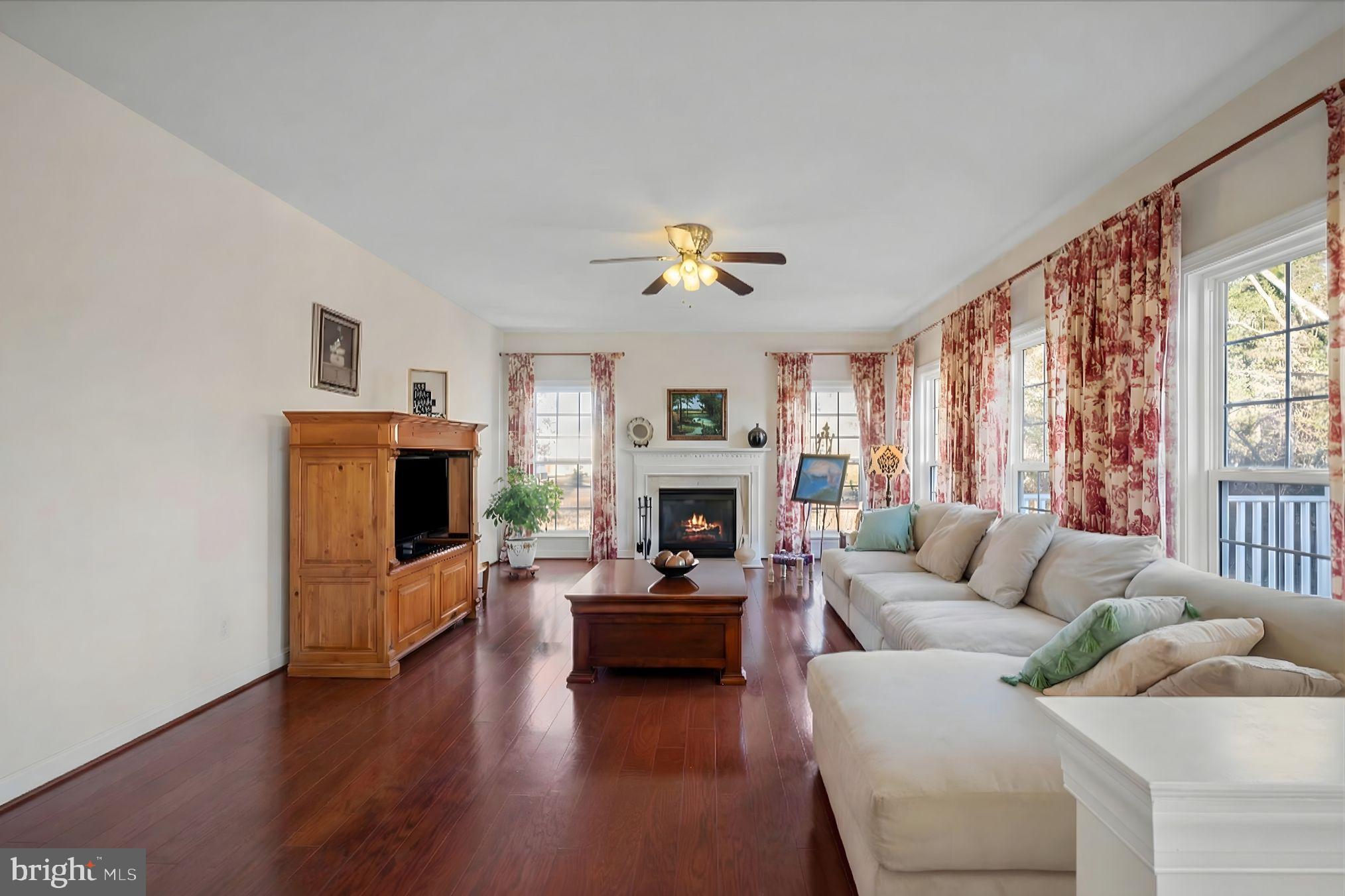 5051 Ridgeview Court Jeffersonton, VA 22724 - Photo 2 of 28 a living room with furniture a fireplace and a large window