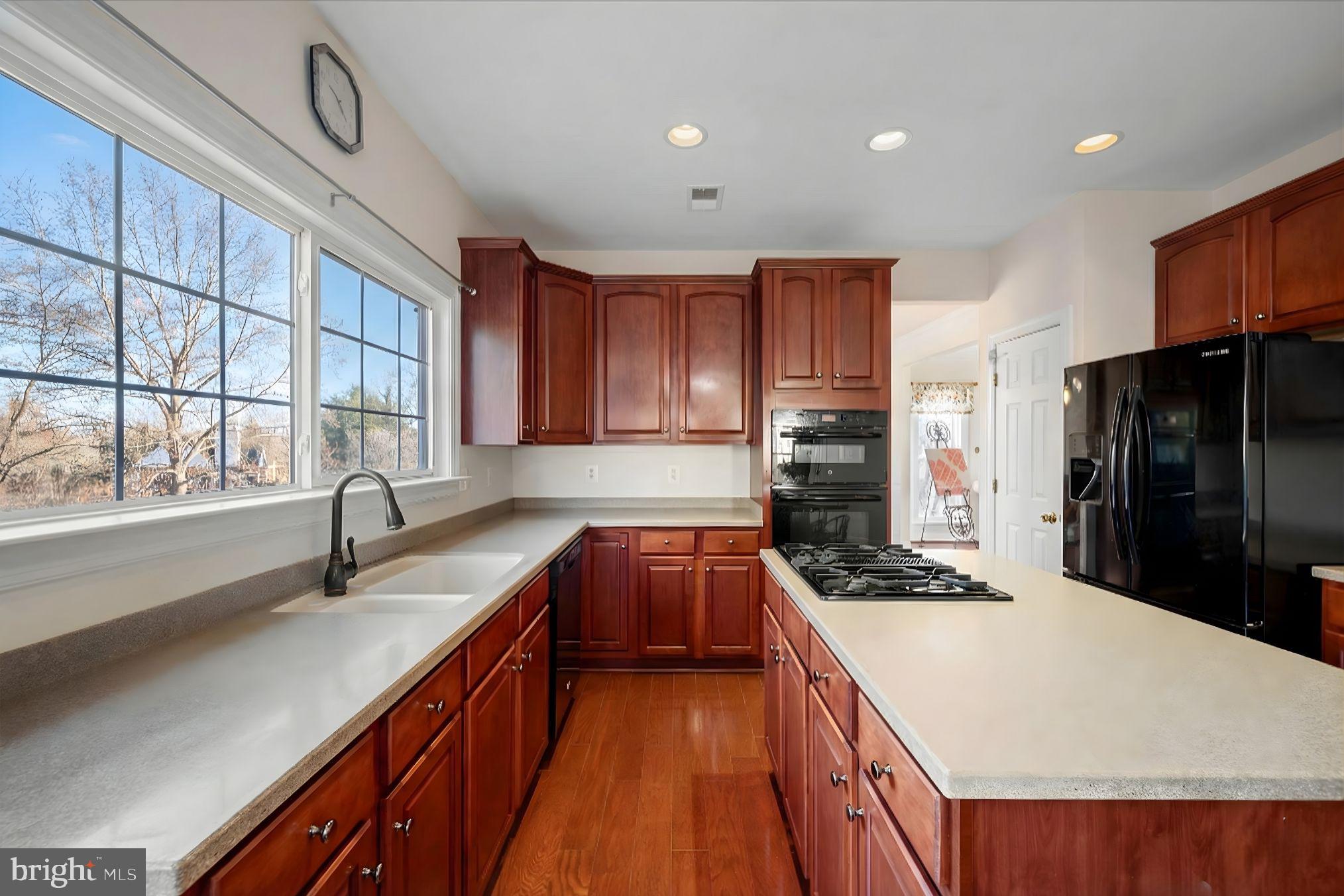 5051 Ridgeview Court Jeffersonton, VA 22724 - Photo 6 of 28 a kitchen with stainless steel appliances granite countertop a sink a stove and a refrigerator