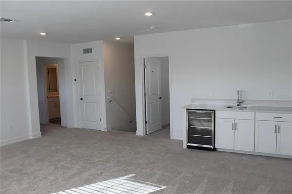an empty room with a bathroom and a sink