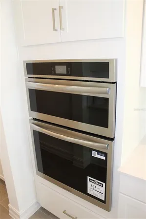 a stove top oven sitting inside of a kitchen