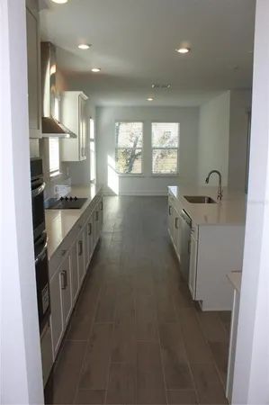 a kitchen with granite countertop a sink and a stove
