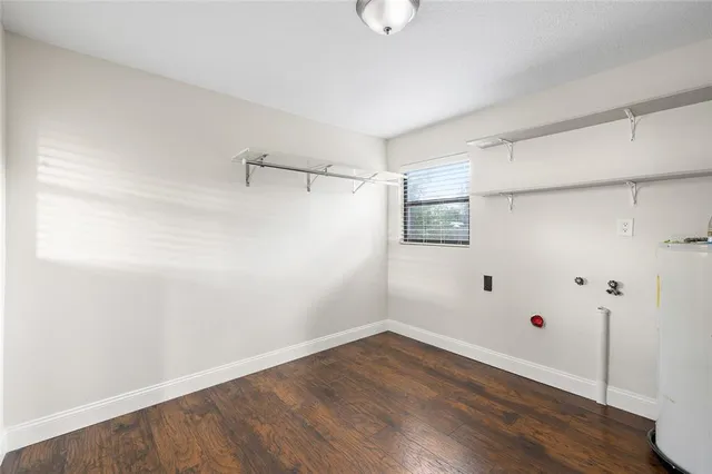 a view of a room with wooden floor and white walls