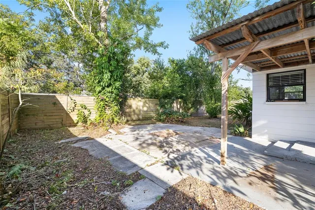 a view of a backyard with plants and a patio