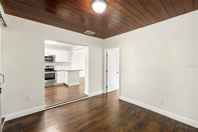 a view of kitchen with wooden floor and electronic appliances