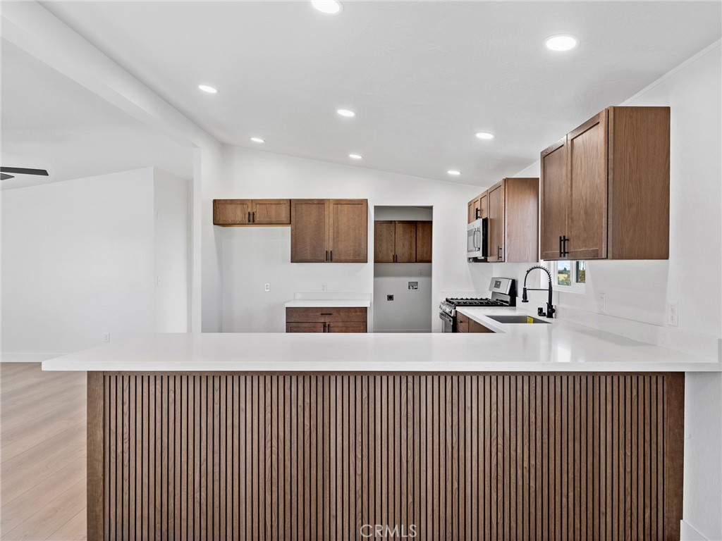 11623 Desert View Road Pinon Hills, CA 92372 - Photo 11 of 47 a kitchen with stainless steel appliances granite countertop wooden cabinets a sink and a granite counter tops