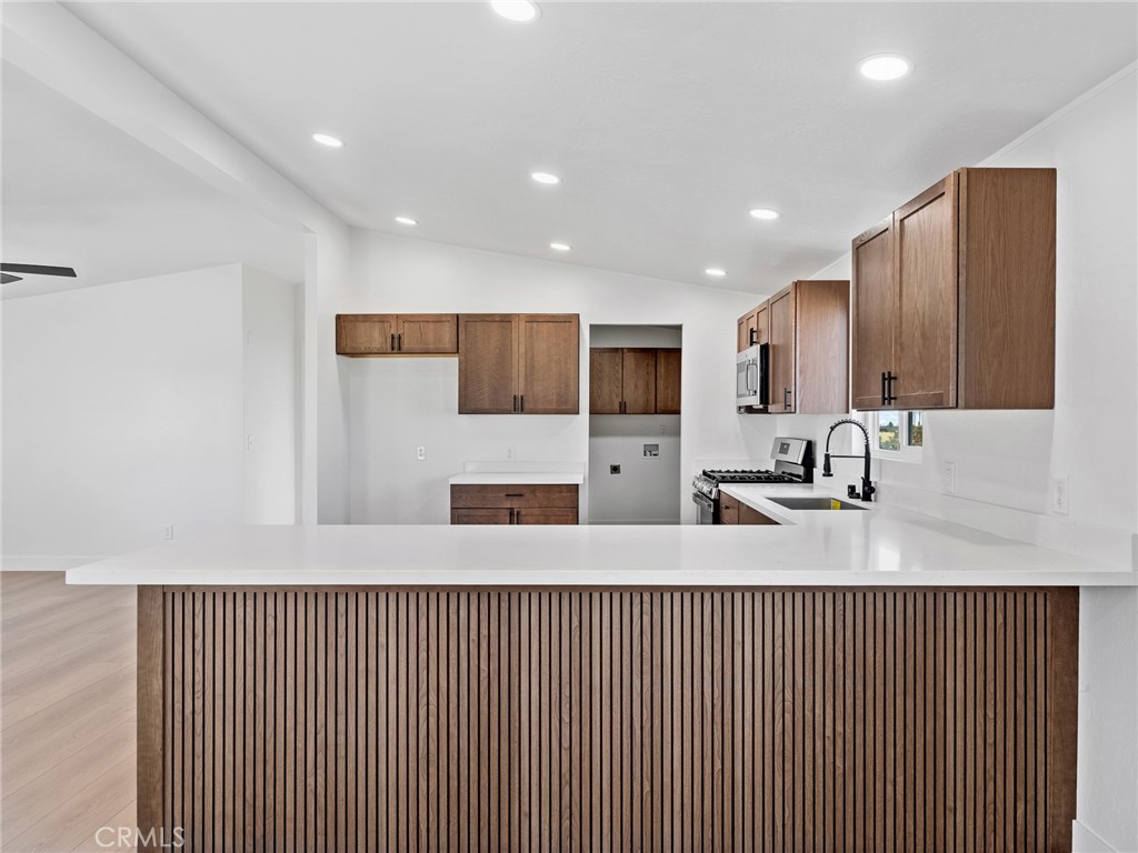 11623 Desert View Road Pinon Hills, CA 92372 - Photo 11 of 47 a kitchen with stainless steel appliances granite countertop wooden cabinets a sink and a granite counter tops