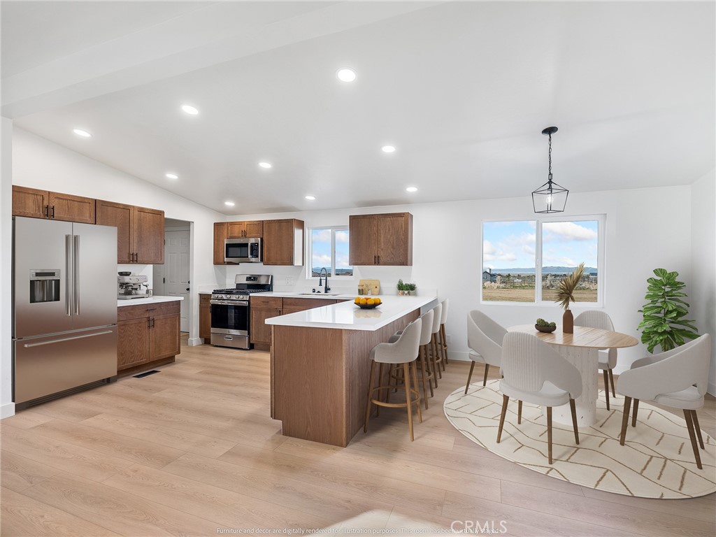 11623 Desert View Road Pinon Hills, CA 92372 - Photo 19 of 47 a large white kitchen with a large island in the center
