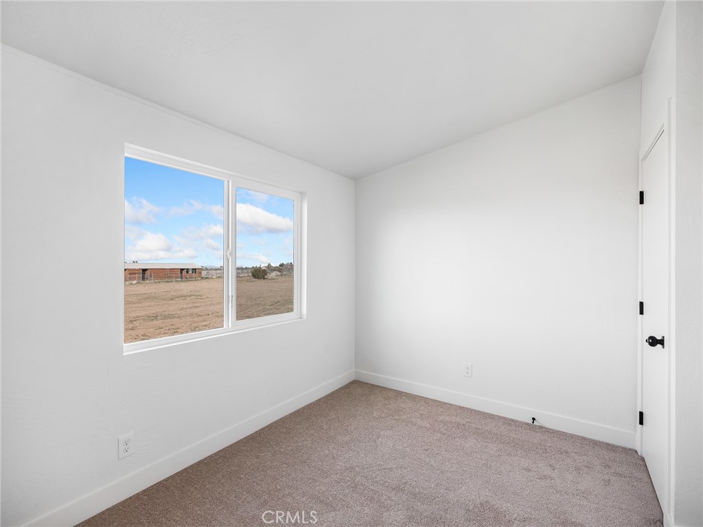 11623 Desert View Road Pinon Hills, CA 92372 - Photo 28 of 47 an empty room with a window