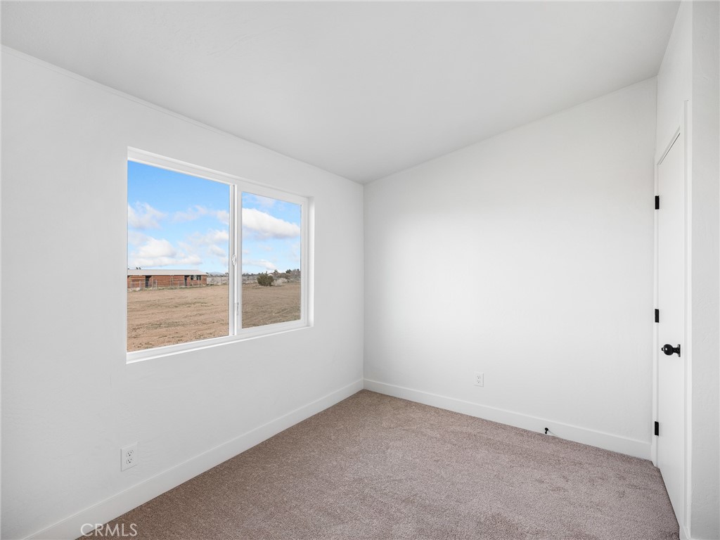 11623 Desert View Road Pinon Hills, CA 92372 - Photo 28 of 47 an empty room with a window