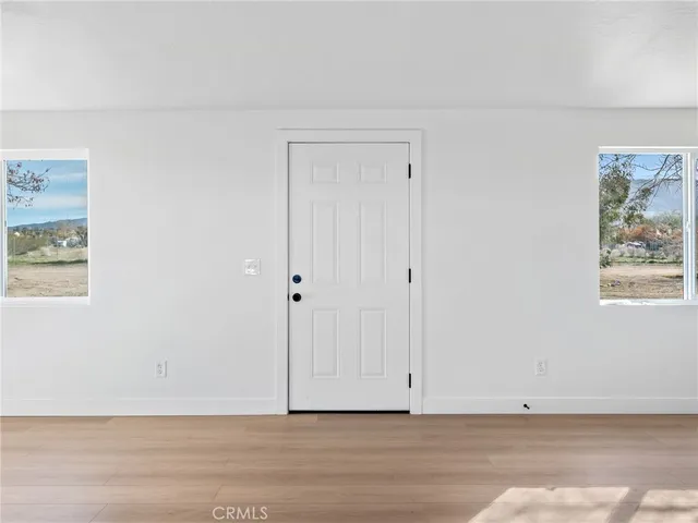 a large kitchen with stainless steel appliances granite countertop a stove top oven a sink dishwasher and a refrigerator with wooden cabinets