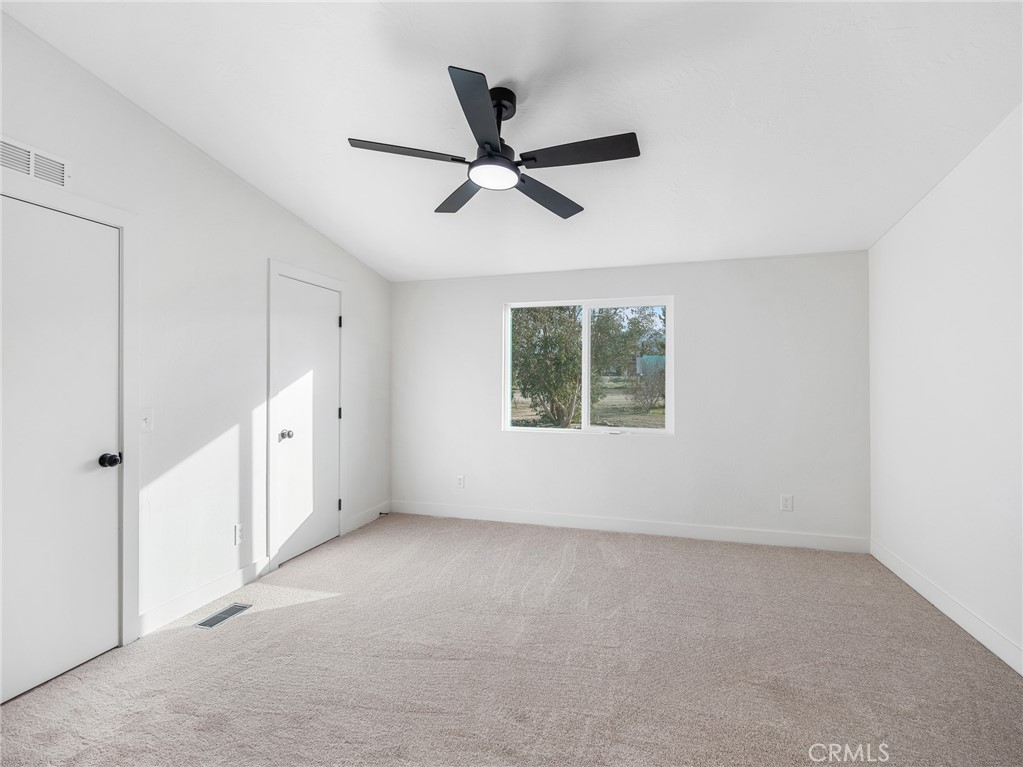 11623 Desert View Road Pinon Hills, CA 92372 - Photo 31 of 47 a view of an empty room with a window