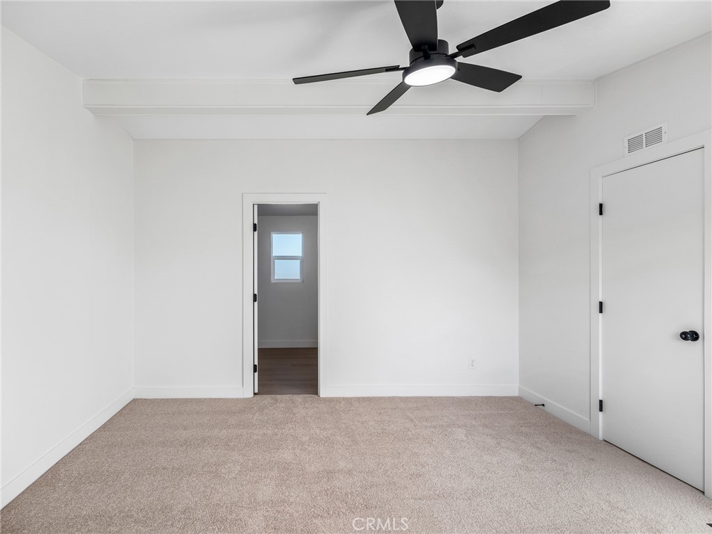 11623 Desert View Road Pinon Hills, CA 92372 - Photo 33 of 47 a view of an empty room with a ceiling fan