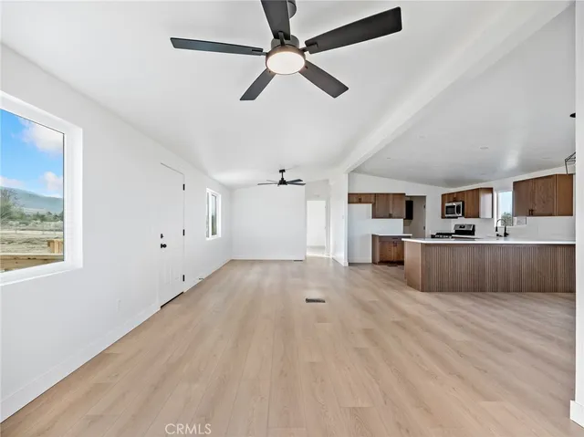 a kitchen with stainless steel appliances granite countertop wooden cabinets a sink and a granite counter tops