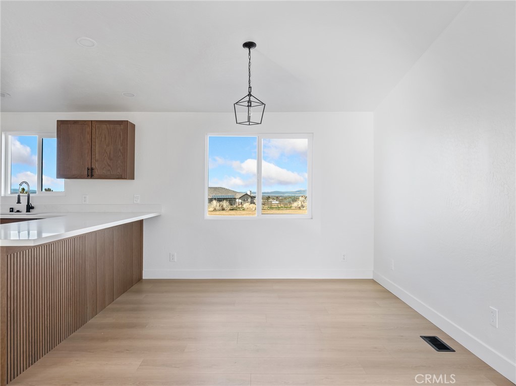 11623 Desert View Road Pinon Hills, CA 92372 - Photo 8 of 47 a view of a kitchen with a sink cabinet and a window