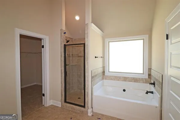 a bathroom with a bathtub and a shower