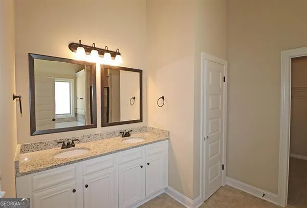 a bathroom with a granite countertop sink mirror and double