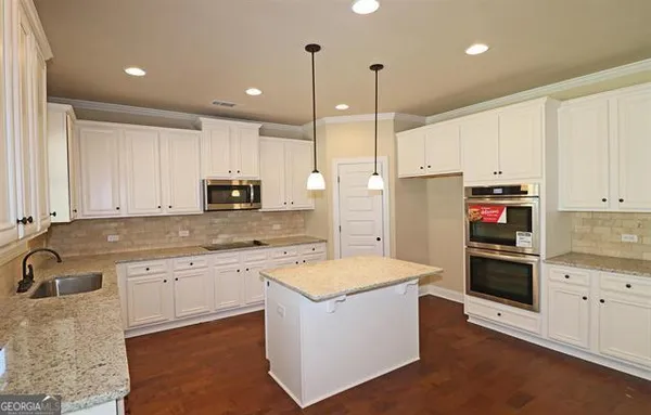 a kitchen with a sink stove and refrigerator