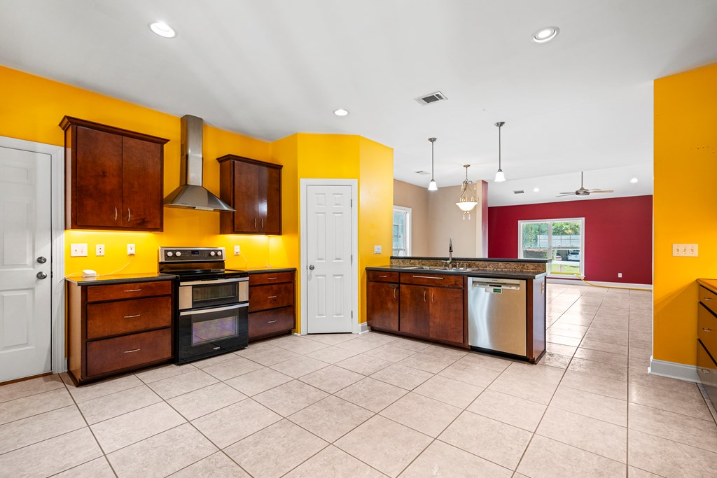 7031 Mellwood Road Columbus, GA 31904 - Photo 5 of 15 a kitchen with stainless steel appliances granite countertop a stove and a refrigerator